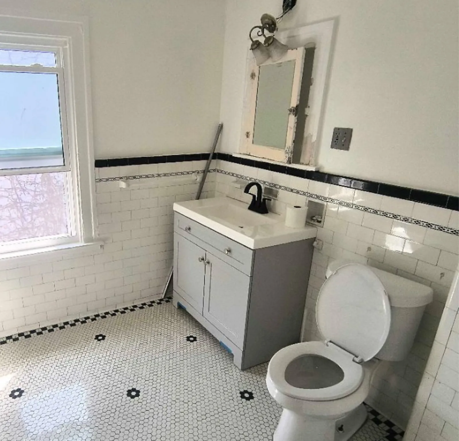 Detailed bathroom clean with black-and-white tile floor and vanity — Verde Luxe Cleaning
